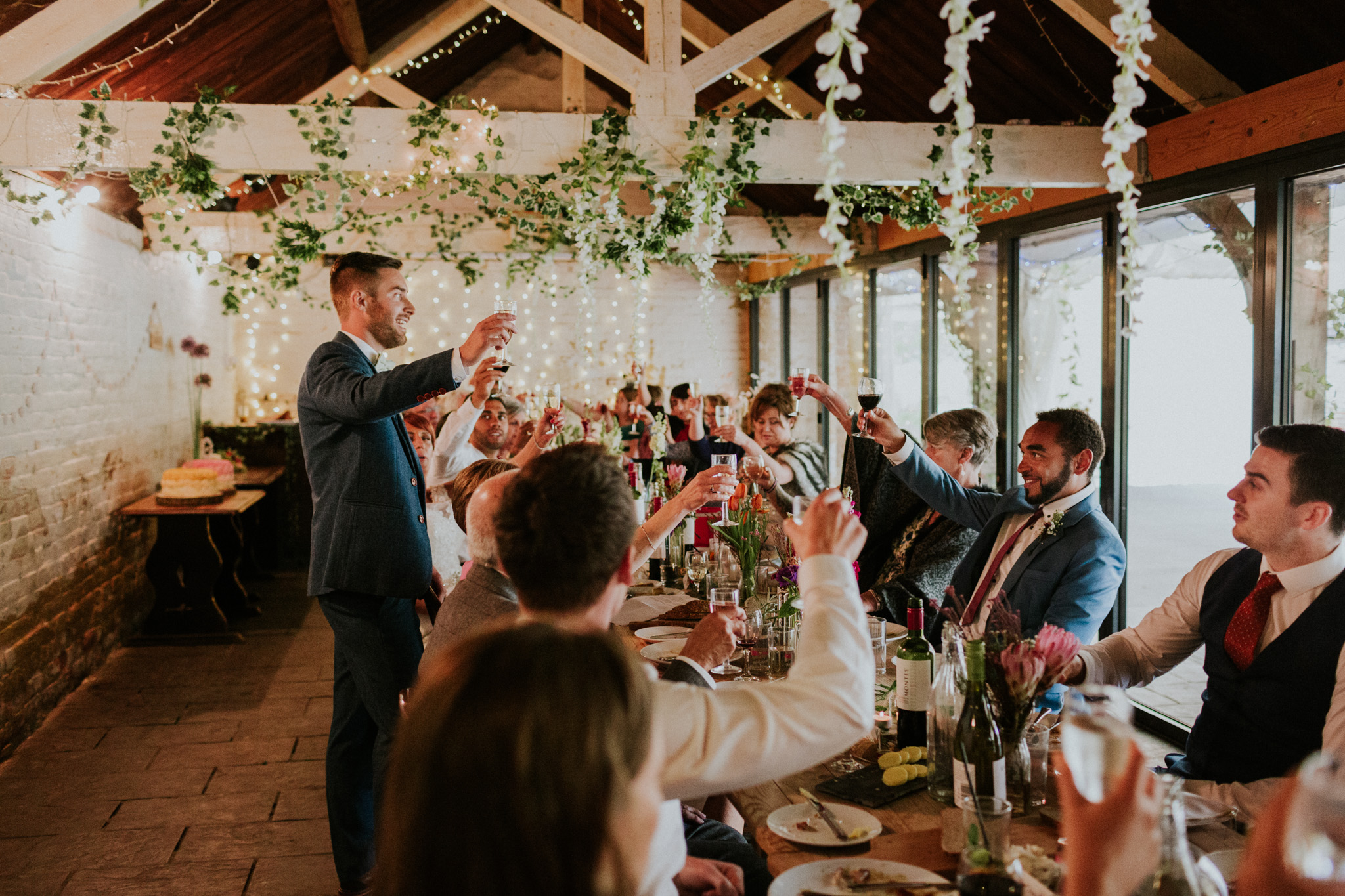groom toasting at wedding reception